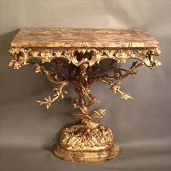 One of a pair of rococo Chippendale casual tables